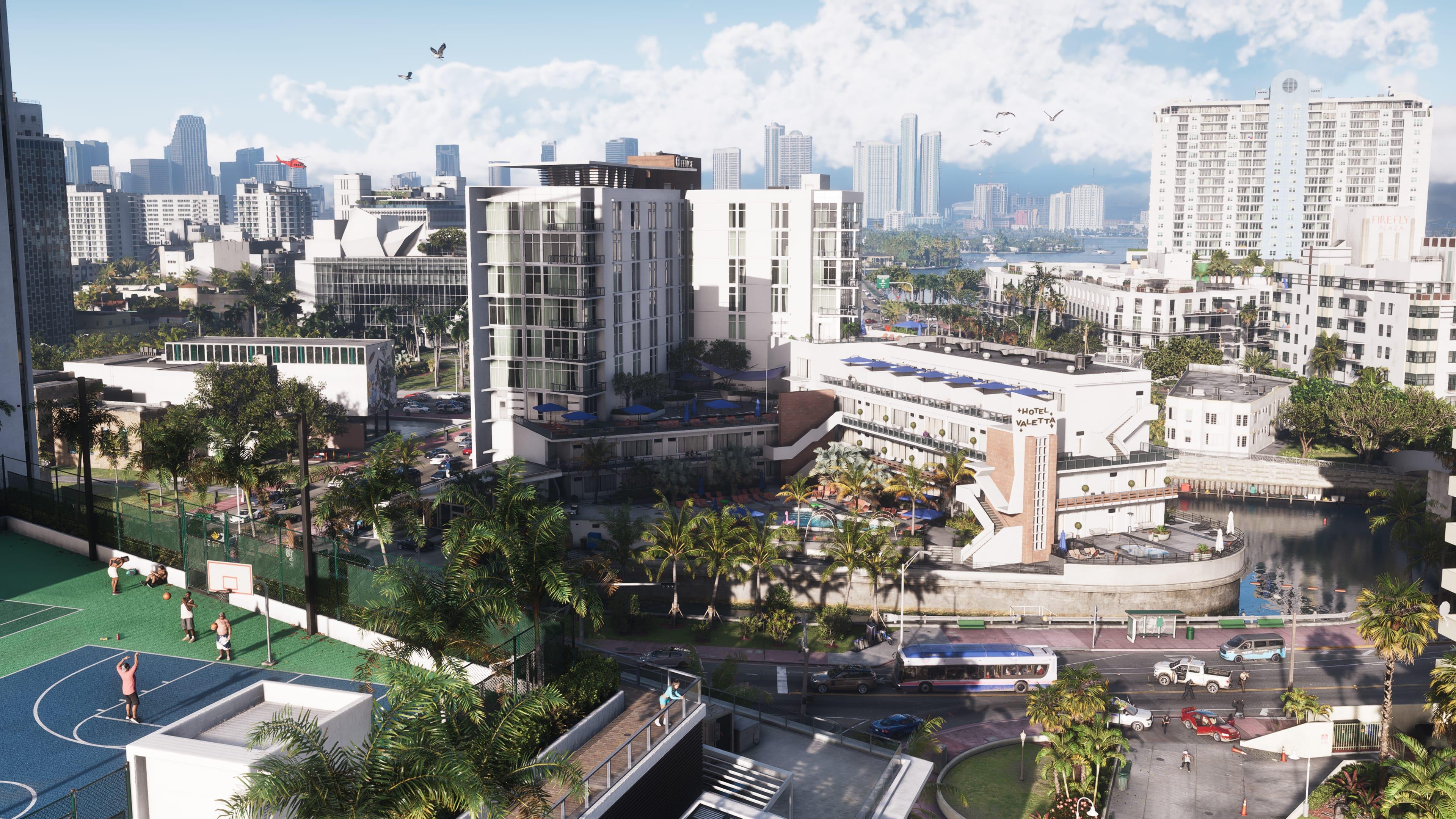 Vue aérienne officielle de Vice City dans Grand Theft Auto VI&nbsp;: hôtels en bord de canal, terrain de basket et gratte-ciels au loin